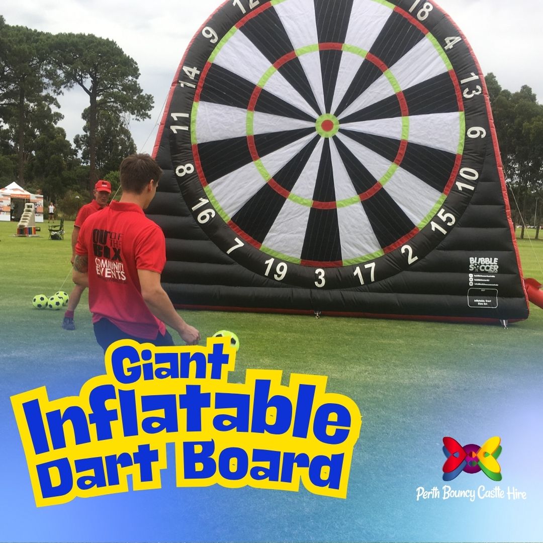 A person playing a game of Giant Inflatable Dart Board by kicking a soccer ball at the target, with the Perth Bouncy Castle Hire logo.