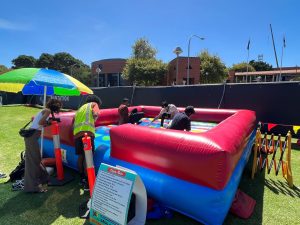 Students playing a giant game of inflatable Twister at a Curtin University event in Bentley.