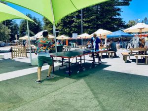An outdoor table tennis table with a shade sail, located at Fremantle Esplanade.