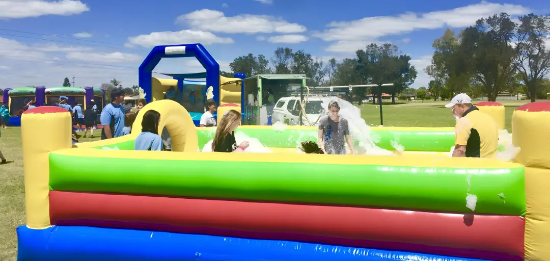 Foam party entertainment at a Perth community event with families, sporting clubs and festival attendees enjoying outdoor activities.